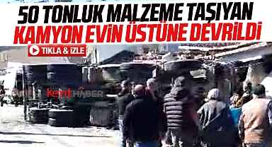 Samsun'da Kocadağ'dan malzeme indiren kamyon evin üzerine devrildi