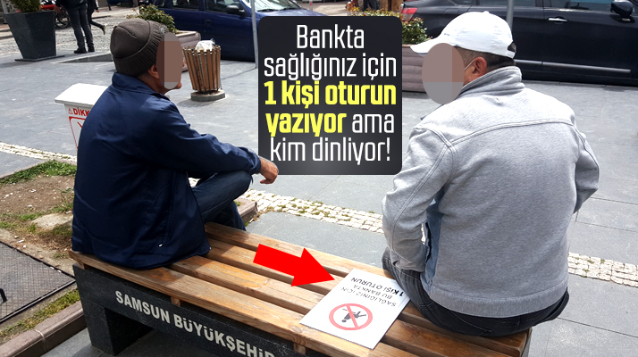 Samsun'da bankta bir kişi oturun uyarısı var ama vatandaş dikkate almıyor
